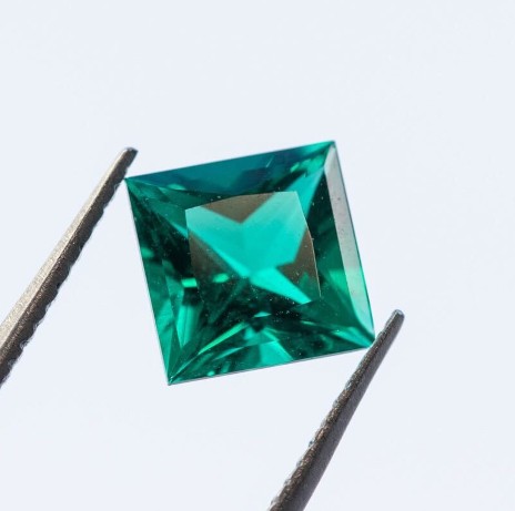 Emerald held in tweezers