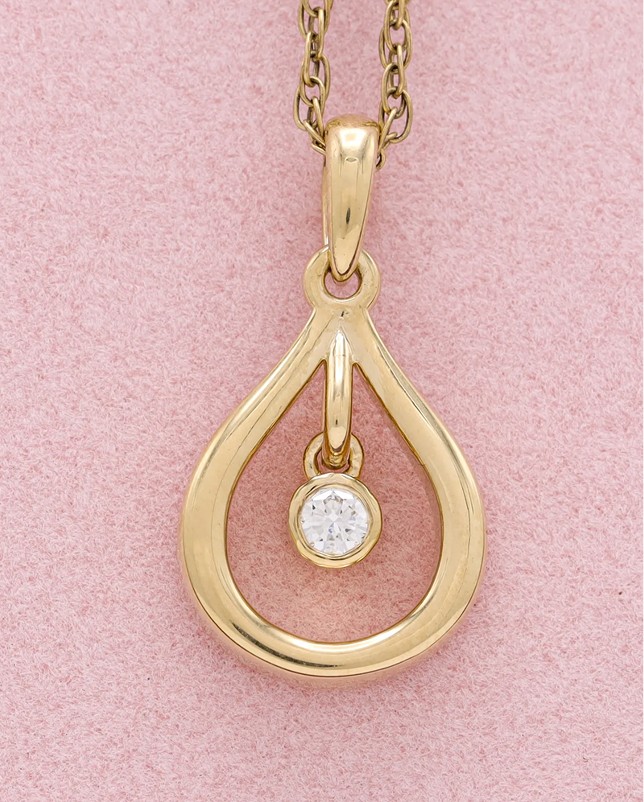 Gold teardrop pendant with dangling diamond