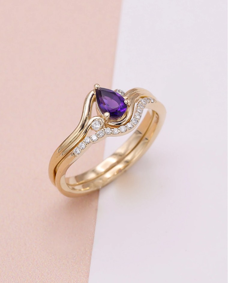 Engagement ring set with pear cut amethyst center stone