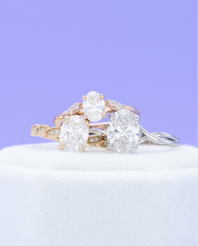 Three stacked diamond rings in white, yellow and rose gold
