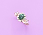 Green sapphire engagement ring with diamond halo